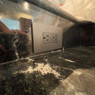 Kitchen Countertop Electric Outlet With Reflection In Surface