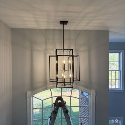 Modern Black Chandelier With Shadows In Room Window Light