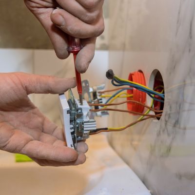 Installing Light Switch With Screwdriver And Electrical Wiring