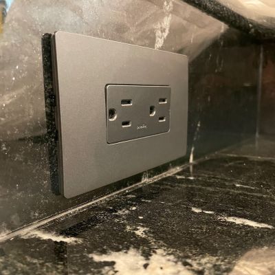 Black Electrical Outlet On Marble Countertop Image