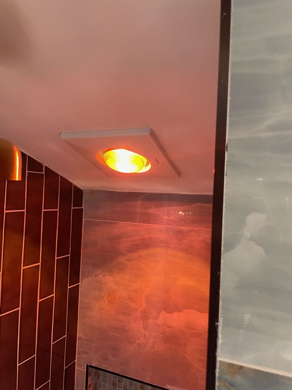 Bathroom Light Fixture With Warm Orange Glow And Tiles Glen Burnie Md