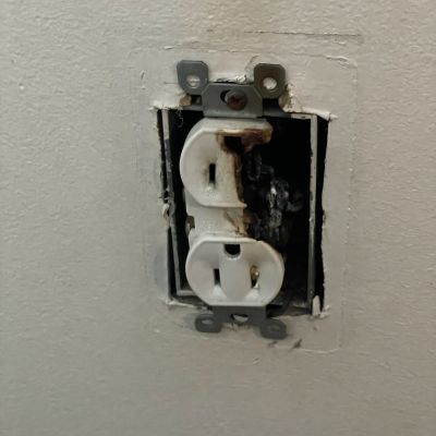Damaged Electrical Outlet With Rust And Exposed Wiring