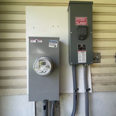 Electric Meter And Emergency Disconnect Box Mounted On Wall
