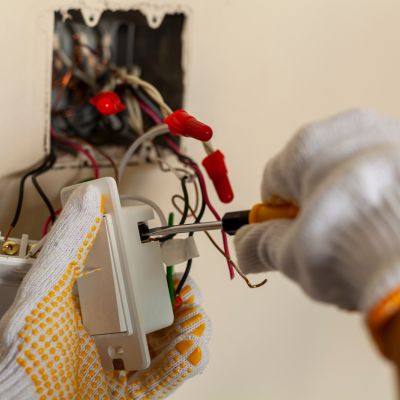 Electrician Working On Wall Switch Wiring Repairing Device