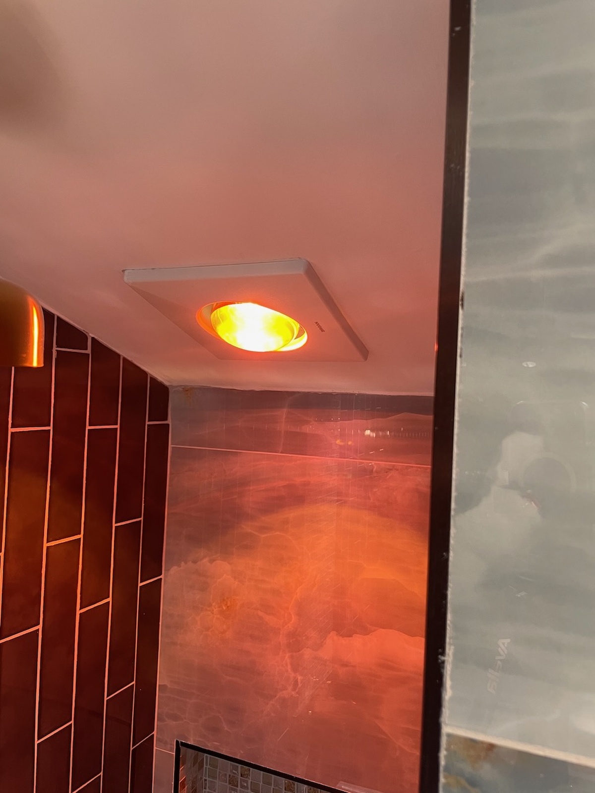 Bathroom Light Fixture With Warm Orange Glow And Tiles Glen Burnie Md