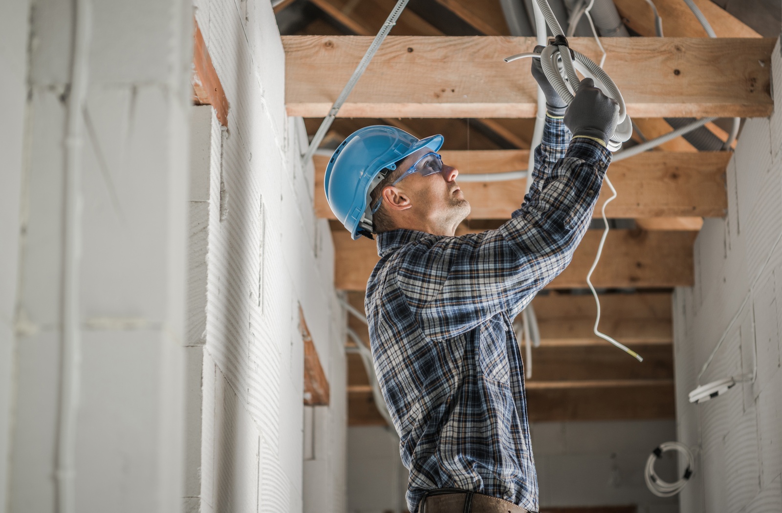 Construction Worker Installing Wiring In Ceiling Photo Glen Burnie Md
