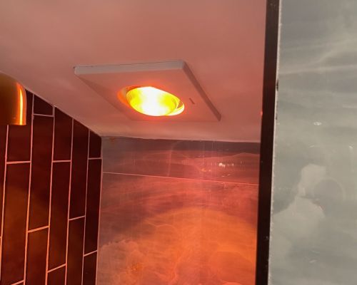 Bathroom Light Fixture With Warm Orange Glow And Tiles Elkridge Md