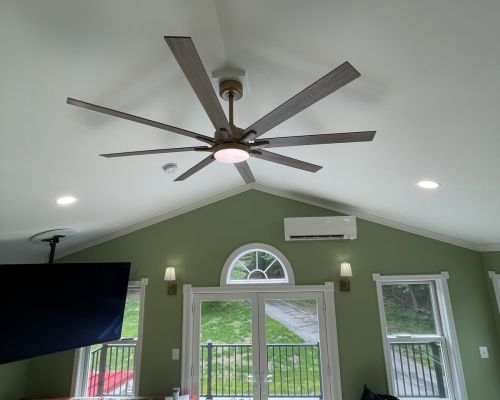 Living Room With Ceiling Fan And Green Walls And Doors Entrance Severn Md