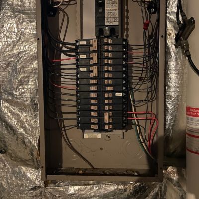 Breaker Panel In Basement With Wires And Insulation