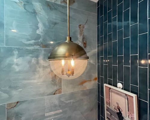 Bathroom Lighting With Blue Tiled Walls And Artwork