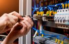 Electrical Panel Wiring Repair With Screwdriver In Hand