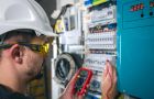 Electrician Testing Circuit With Multimeter In Industrial Setting