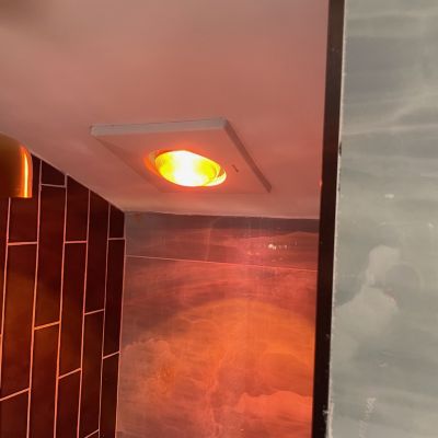 Bathroom Light Fixture With Warm Orange Glow And Tiles