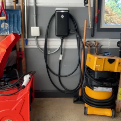 Garage With Tools And Ev Charger Installed Wall