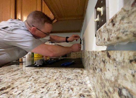 Kitchen Repairing Electric Outlet By Contractor In Action