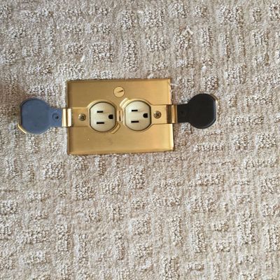 Gold Wall Outlet With Switch Cover On Carpet